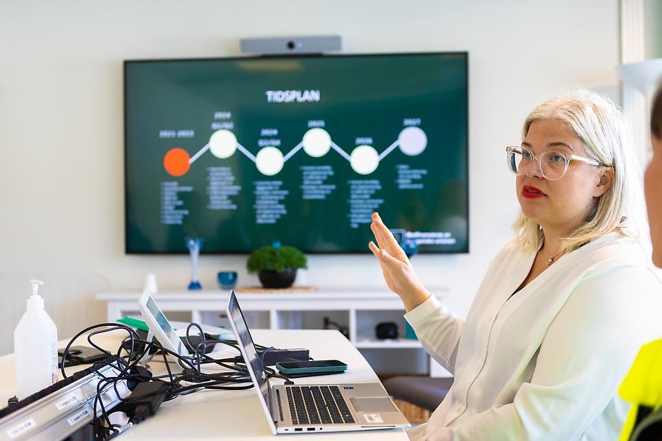 Kvinna visar diagram på skärm.