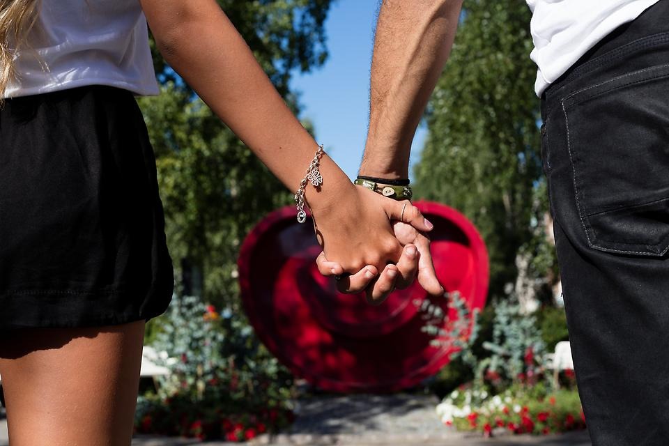 Två personer håller varandra i hand