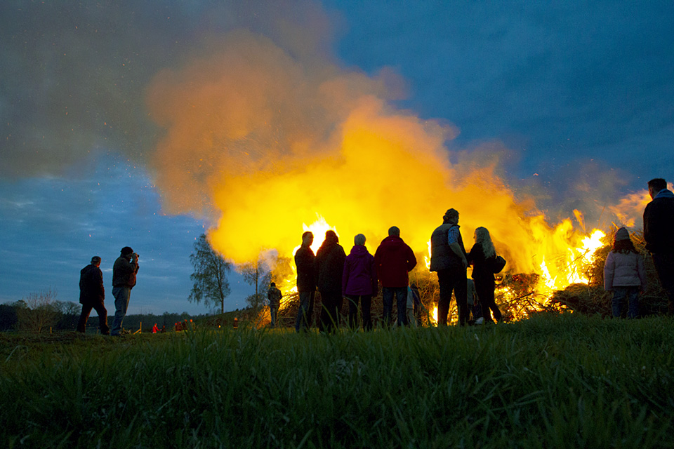 Majbrasa, folk som skuggor i förgrunden