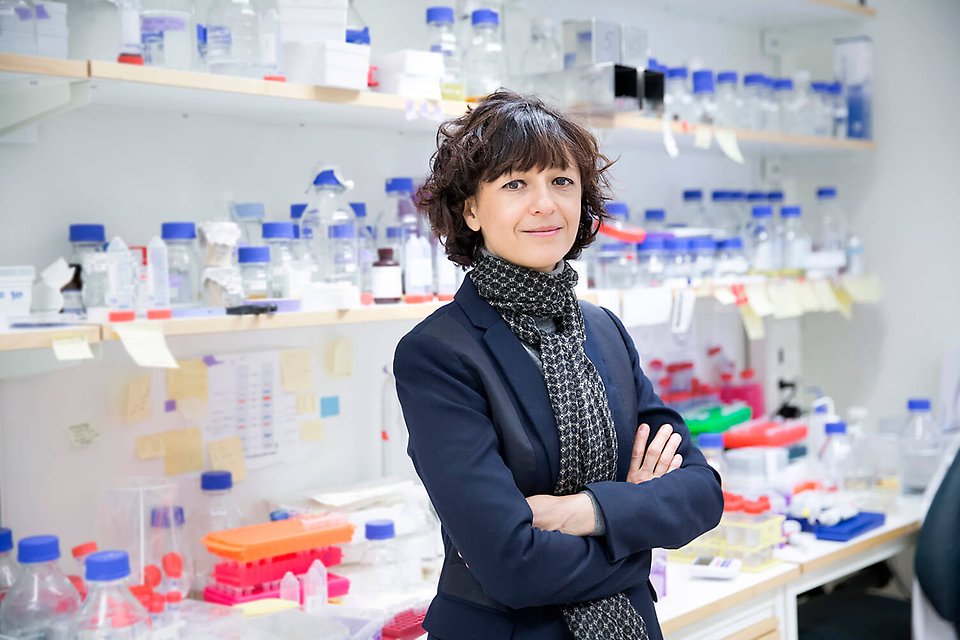 Photograph of Emmanuelle Charpentier in a lab environment.
