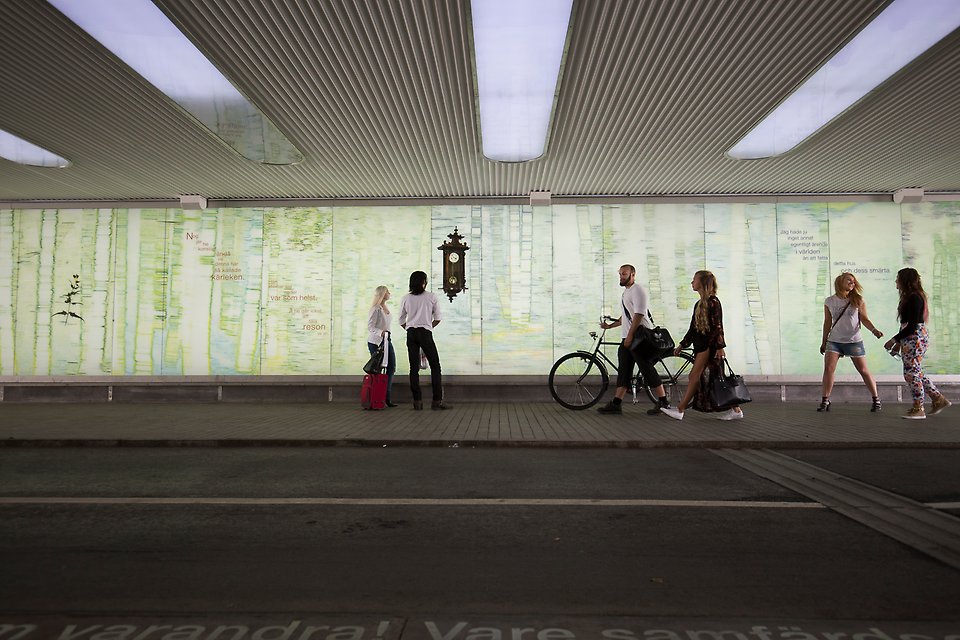 People walking through a tunnel.