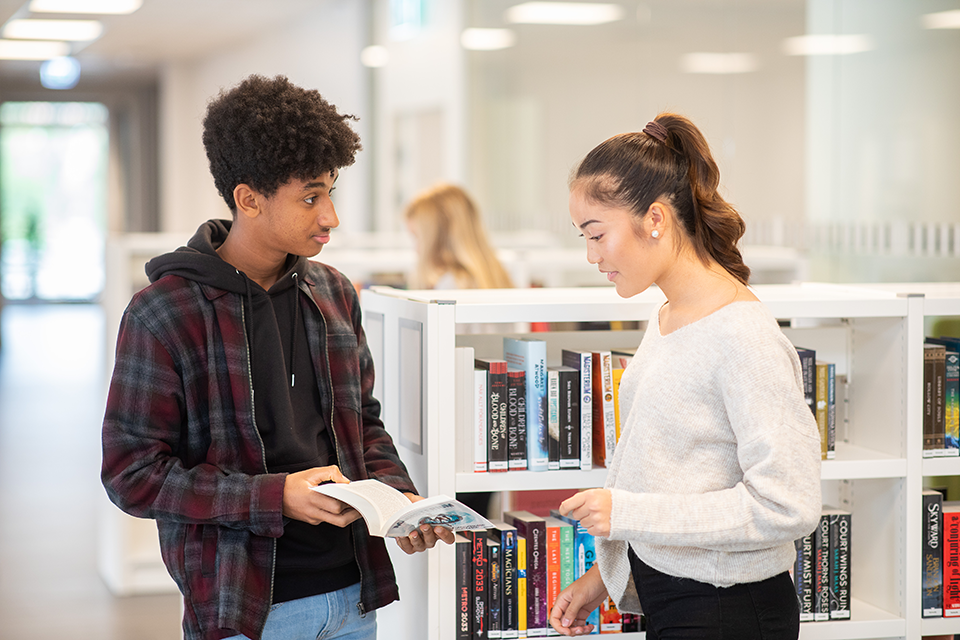 Image of two students talking.