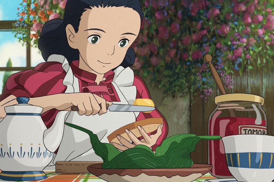 En flicka sitter vid ett dukat frukostbord